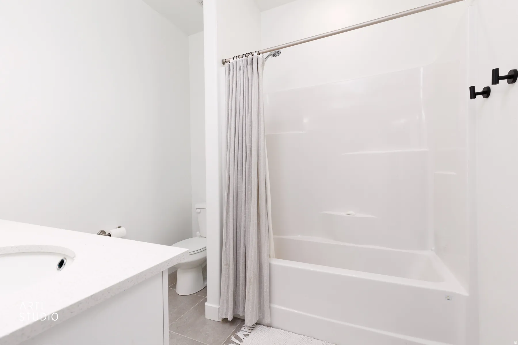 Full bath with vanity, shower / tub combo with curtain, and light tile patterned floors