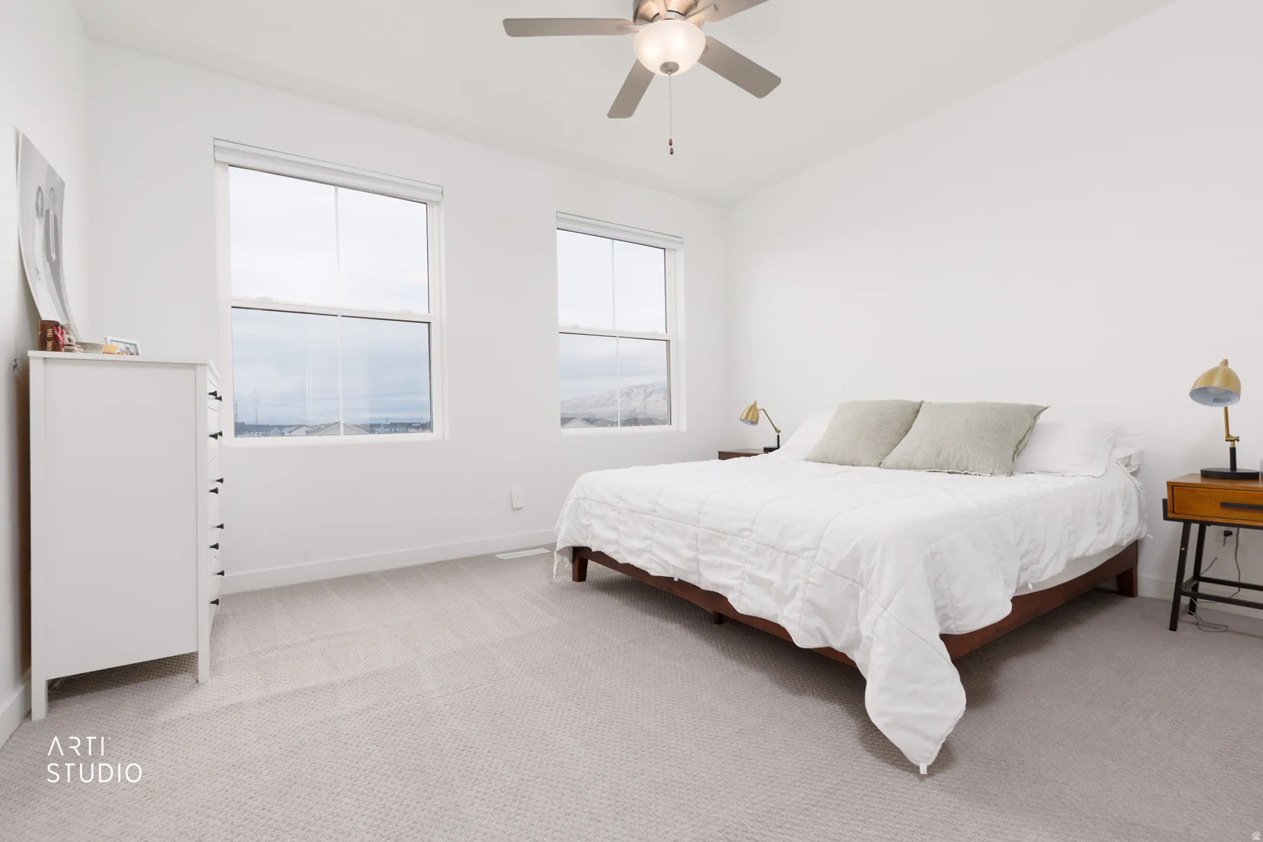 Bedroom featuring light colored carpet and a ceiling fan