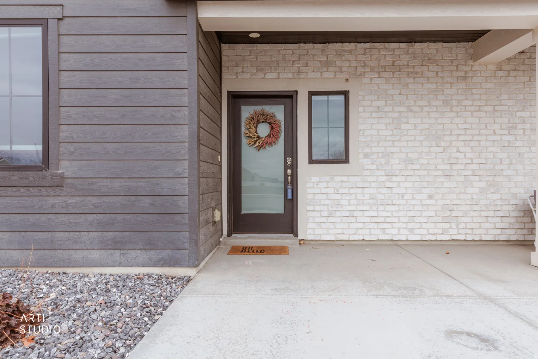 Entrance to property featuring brick siding