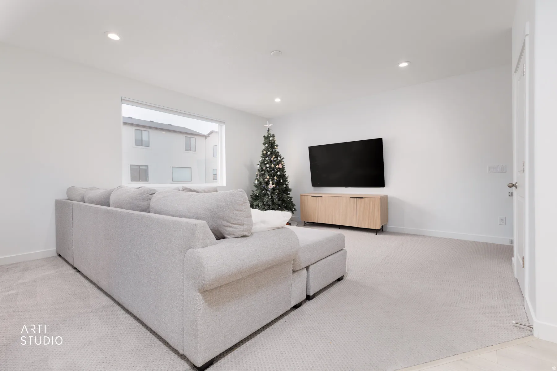 Living room with recessed lighting and light colored carpet