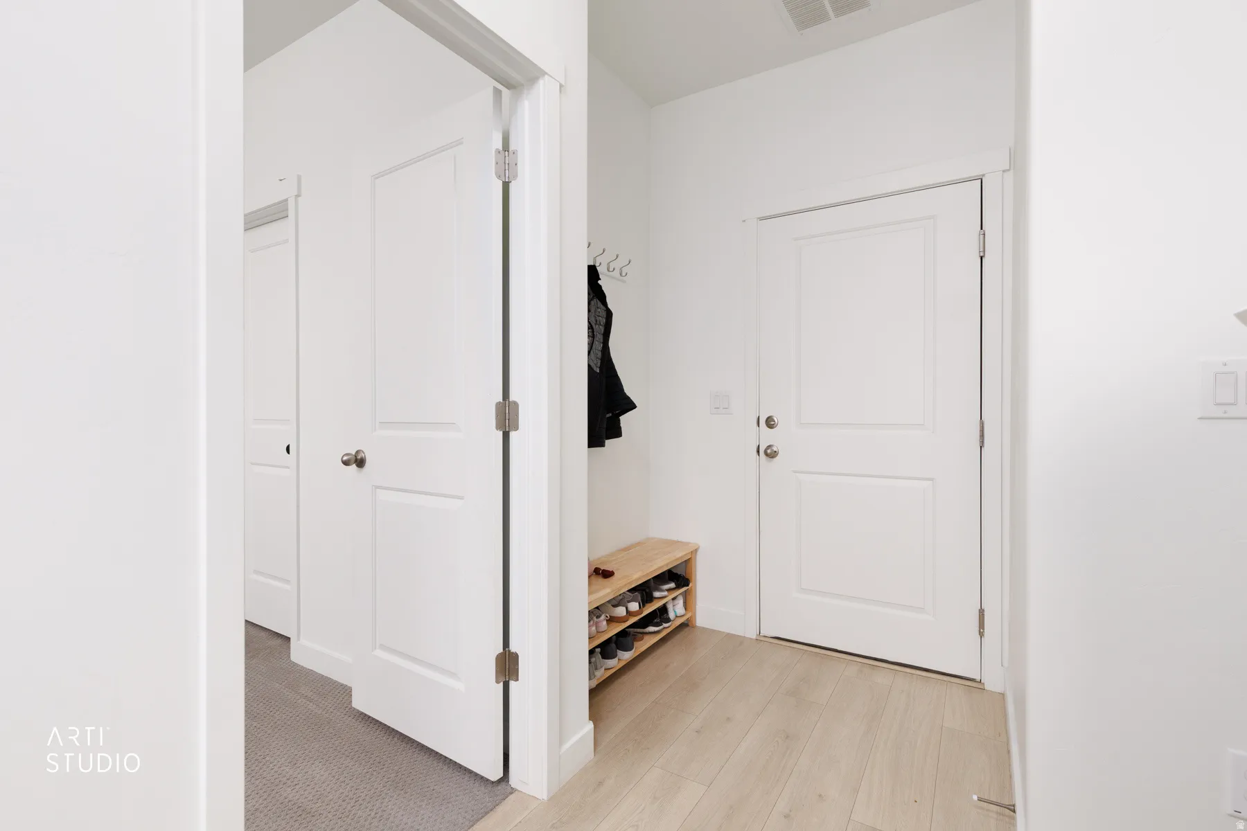 Mudroom with light wood-style flooring