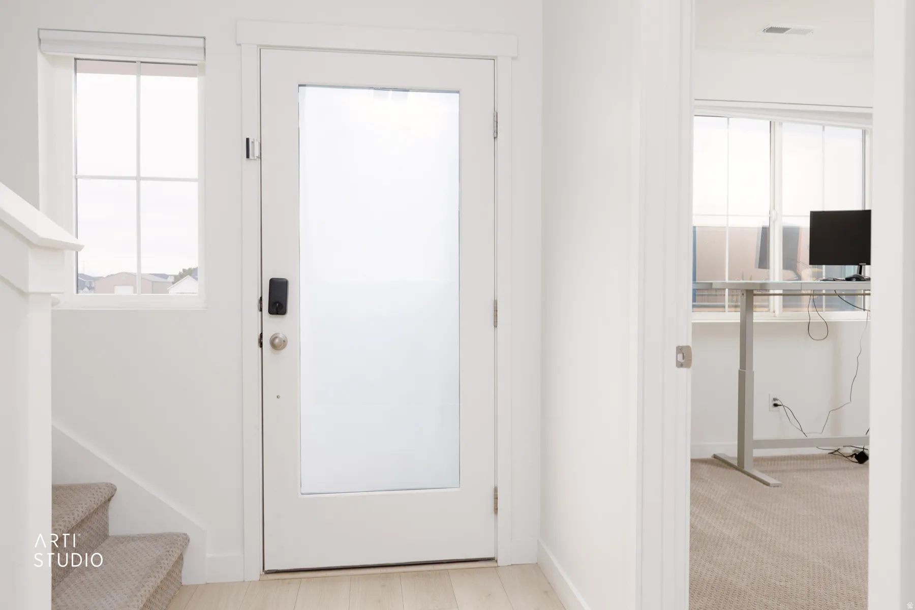 Foyer entrance featuring healthy amount of natural light and stairway