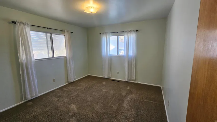 Bedroom 2 featuring dark carpet and plenty of natural light
