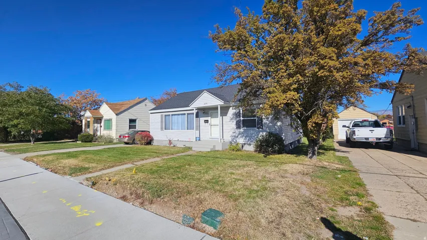 Bungalow-style home featuring a front lawn and a residential view