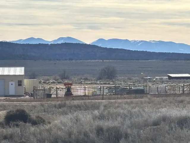 View of mountain backdrop with rural landscape