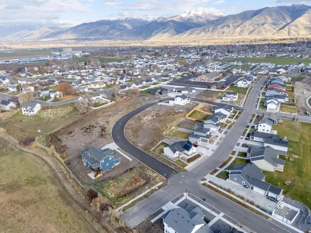 Aerial overview of property's location with nearby suburban area and a mountain backdrop