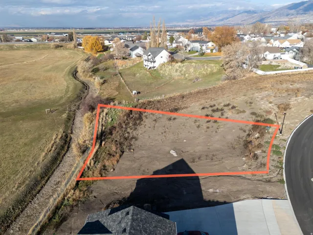 Aerial view of residential area with property parcel outlined