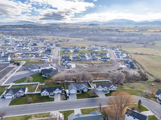 Aerial overview of property's location with nearby suburban area and a mountain backdrop