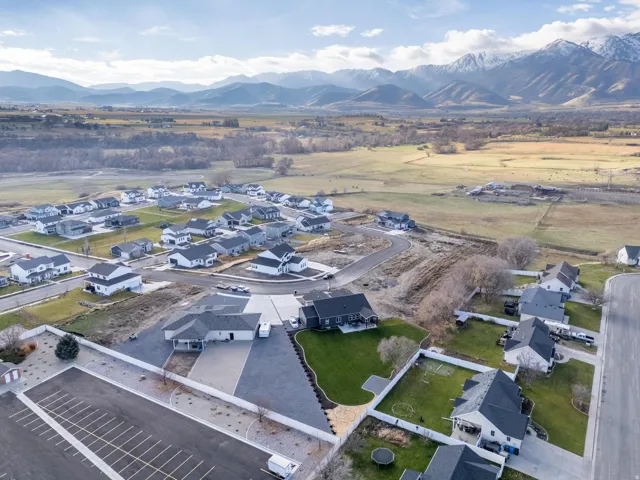 Aerial view of property's location with nearby suburban area and mountains