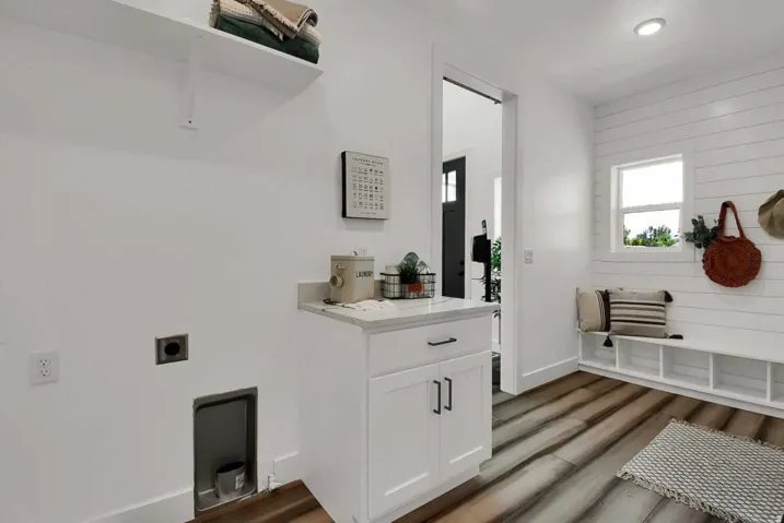 Laundry room featuring electric dryer hookup and light wood-type flooring
