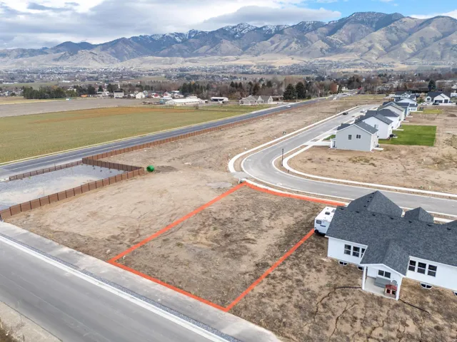 Aerial view of property and surrounding area featuring mountains and property boundaries highlighted