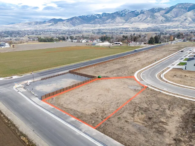 Aerial view of property's location featuring a mountainous background and property parcel outlined
