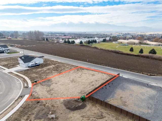 Aerial view of property and surrounding area featuring property parcel outlined