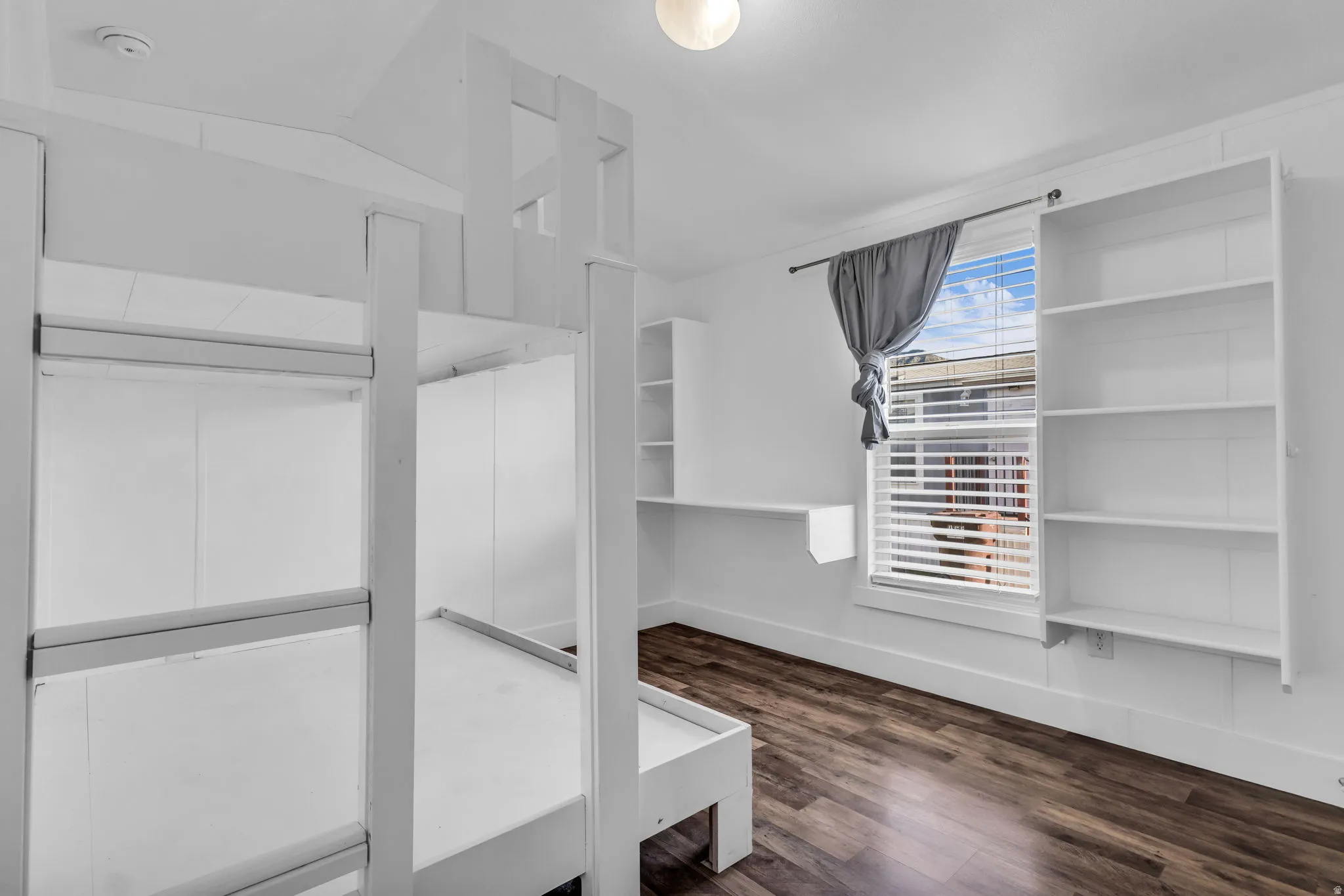 Walk in closet featuring dark wood finished floors