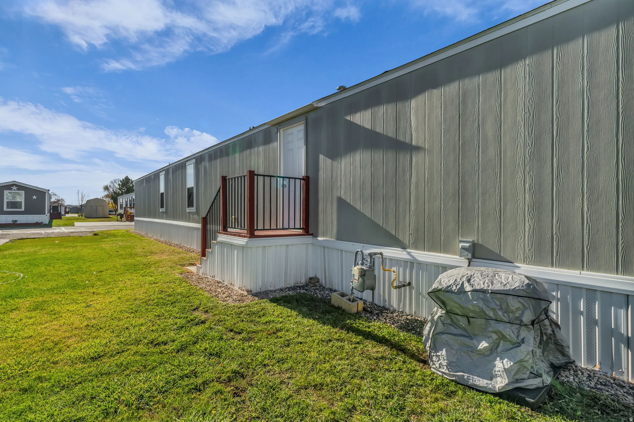 View of property exterior featuring a lawn