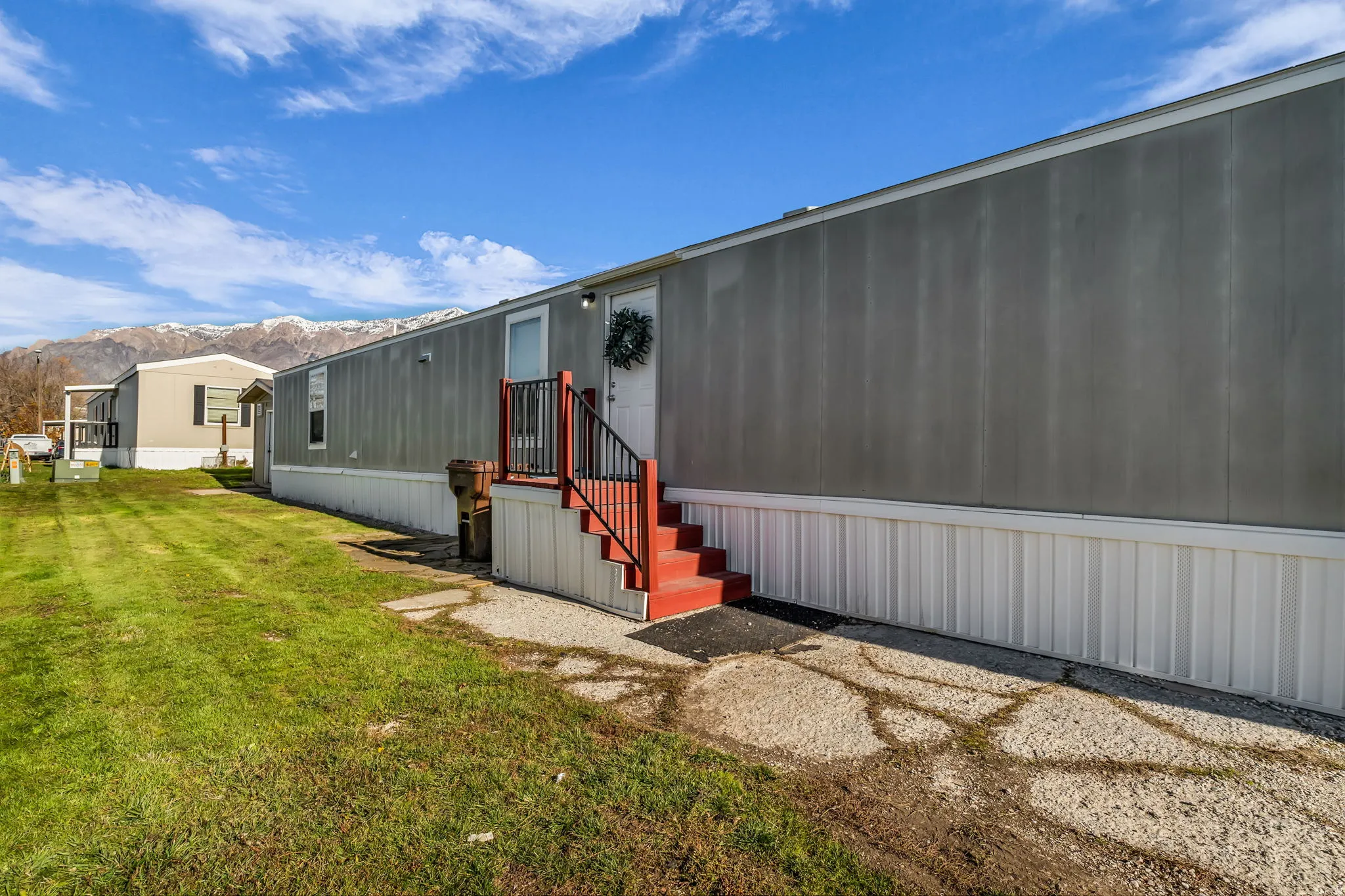 Property entrance featuring a yard and a mountain view