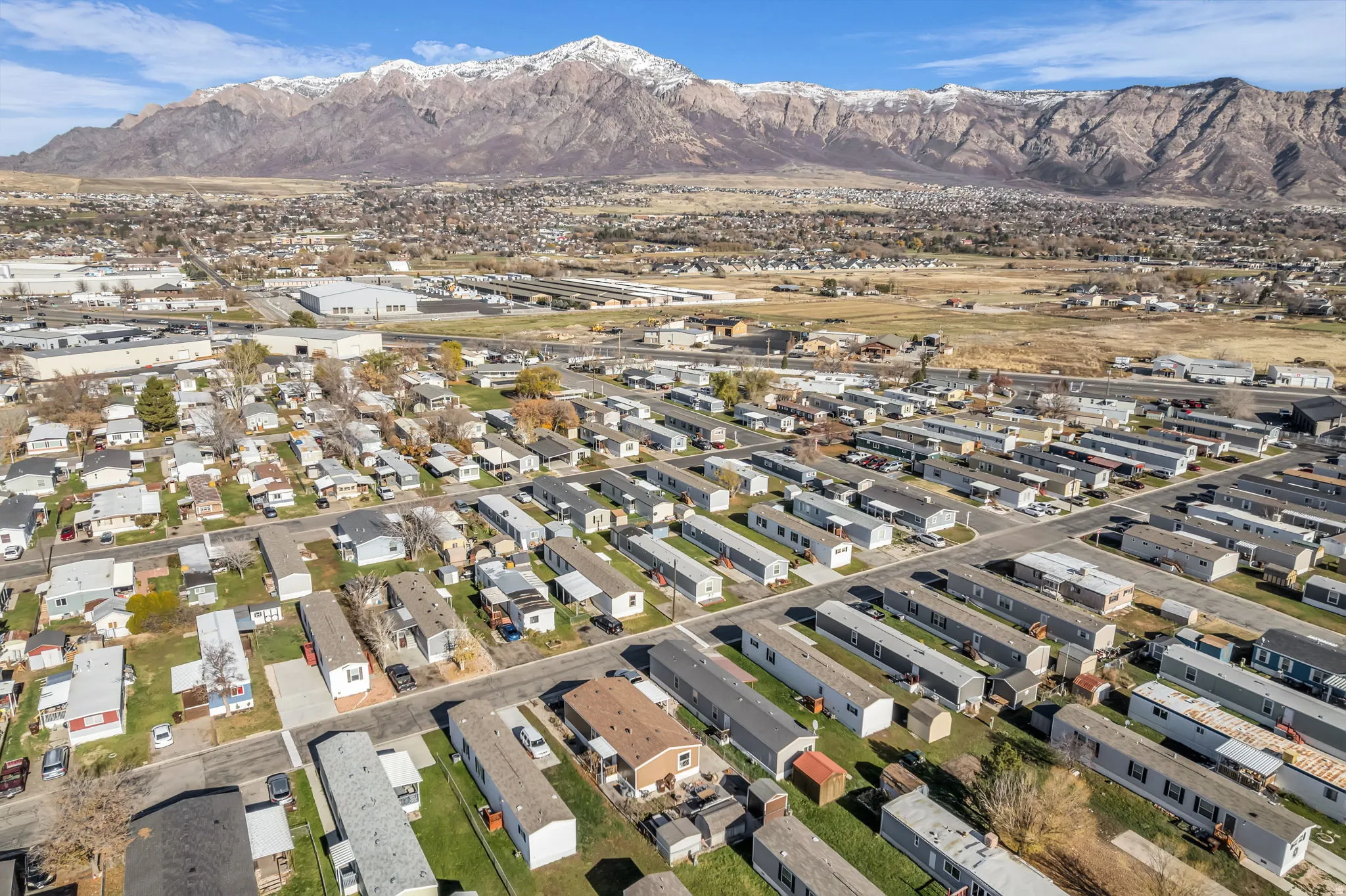 Aerial overview of property's location with nearby suburban area and a mountainous background