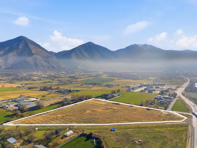 Overview of rural landscape with property boundaries highlighted and a mountain backdrop