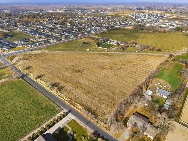 Aerial view of property's location featuring abundant farmland, nearby suburban area, and rural landscape