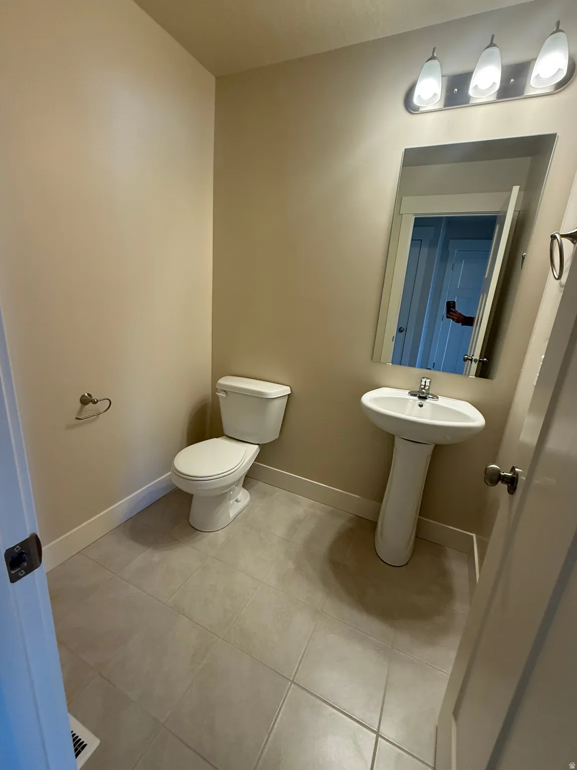 Bathroom with baseboards and light tile patterned floors