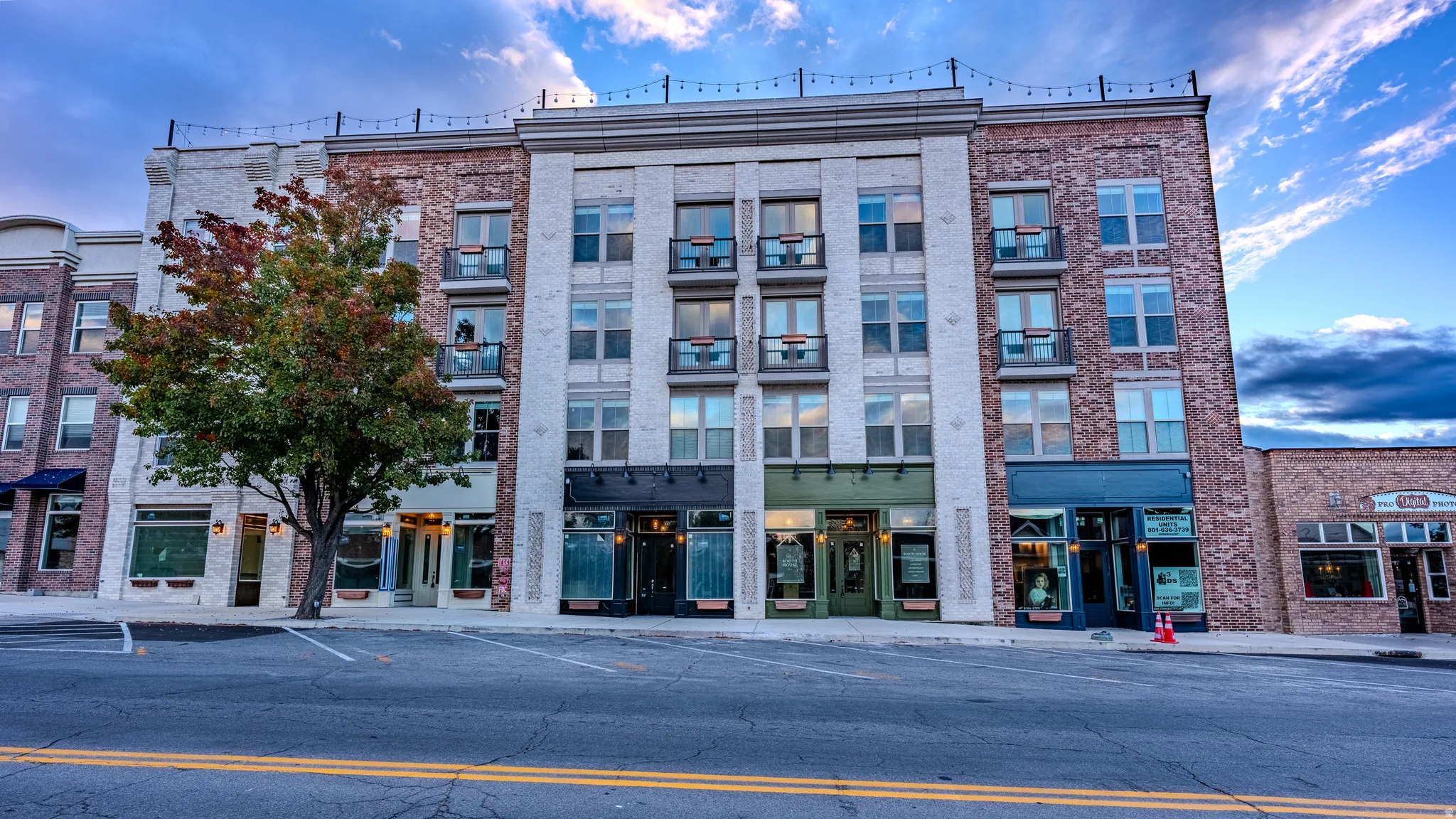 View of building exterior with uncovered parking