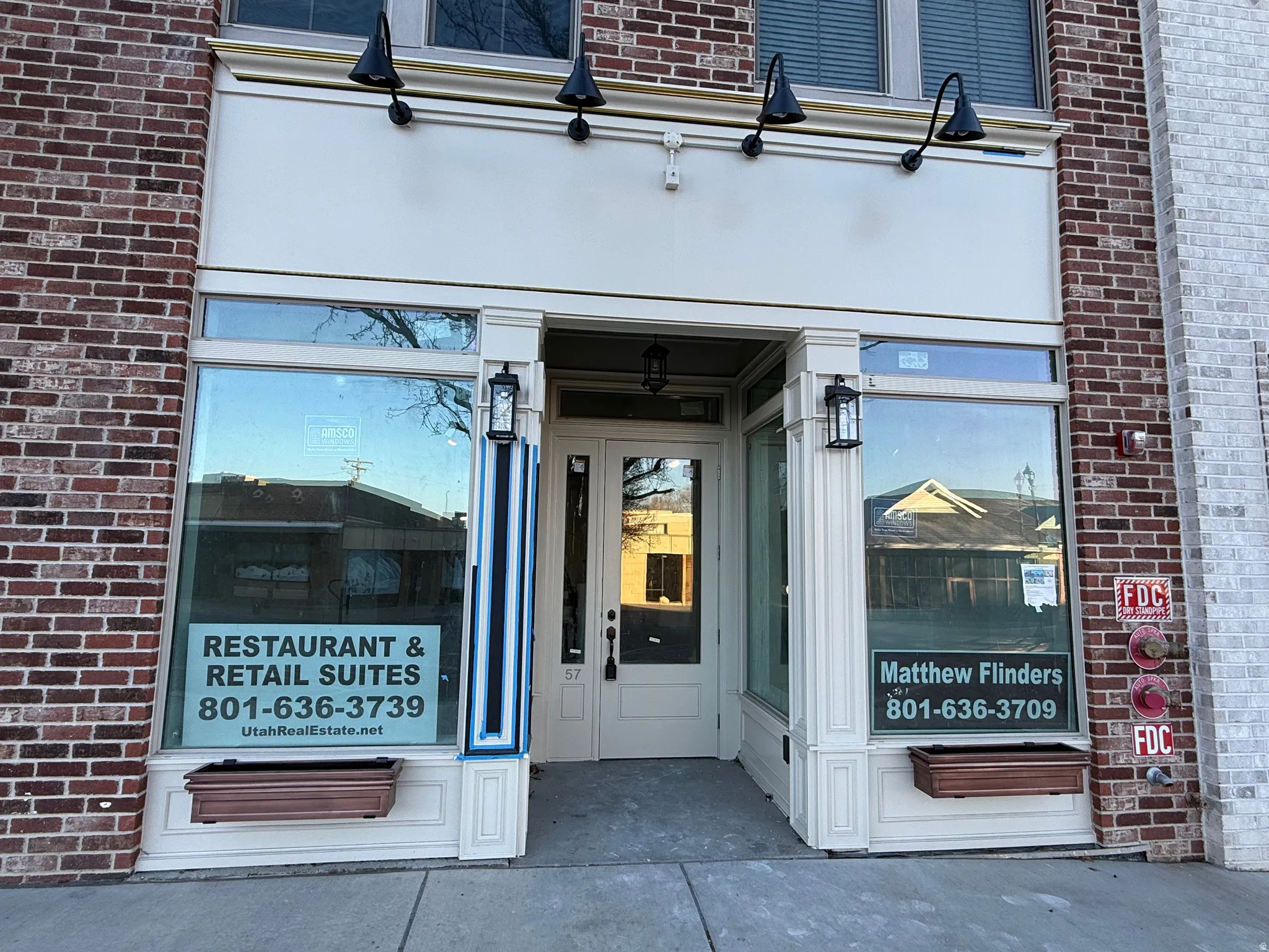View of exterior entry featuring brick siding