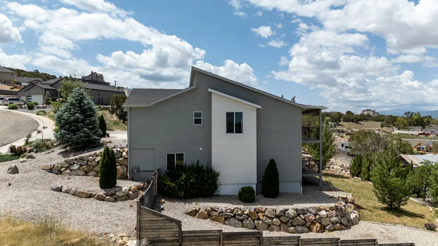 View of side of property with stucco siding and a balcony