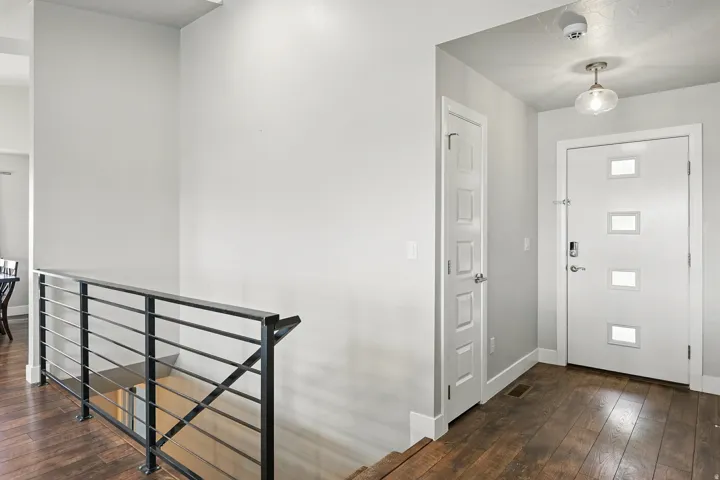Entryway featuring dark wood finished floors and baseboards