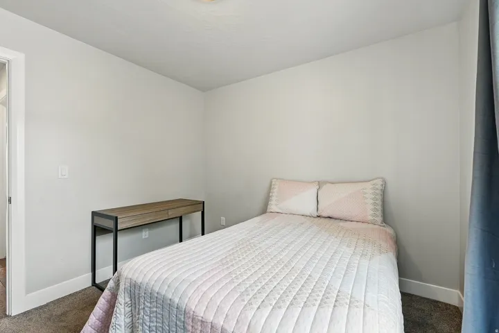 Bedroom featuring dark carpet