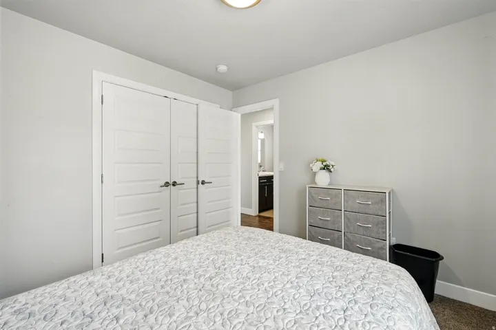 Bedroom featuring a closet and dark carpet