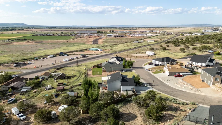 Aerial overview of property's location with a mountain backdrop and nearby suburban area