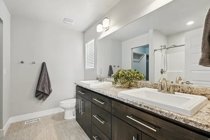 Bathroom with double vanity and a shower