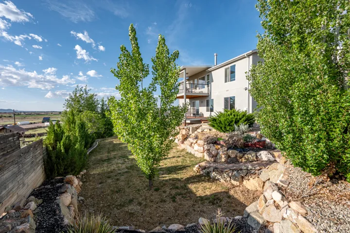 View of yard with a balcony