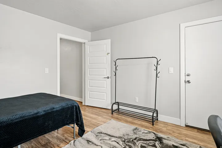Bedroom with light wood-type flooring and baseboards