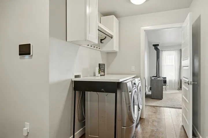 Laundry room featuring cabinet space, hardwood / wood-style flooring, and washer and dryer