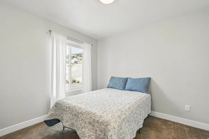 Carpeted bedroom with baseboards