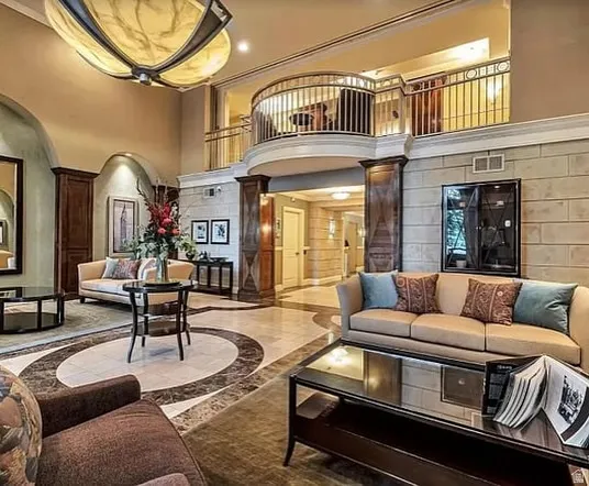 Community lobby featuring a high ceiling, ornamental molding, and recessed lighting
