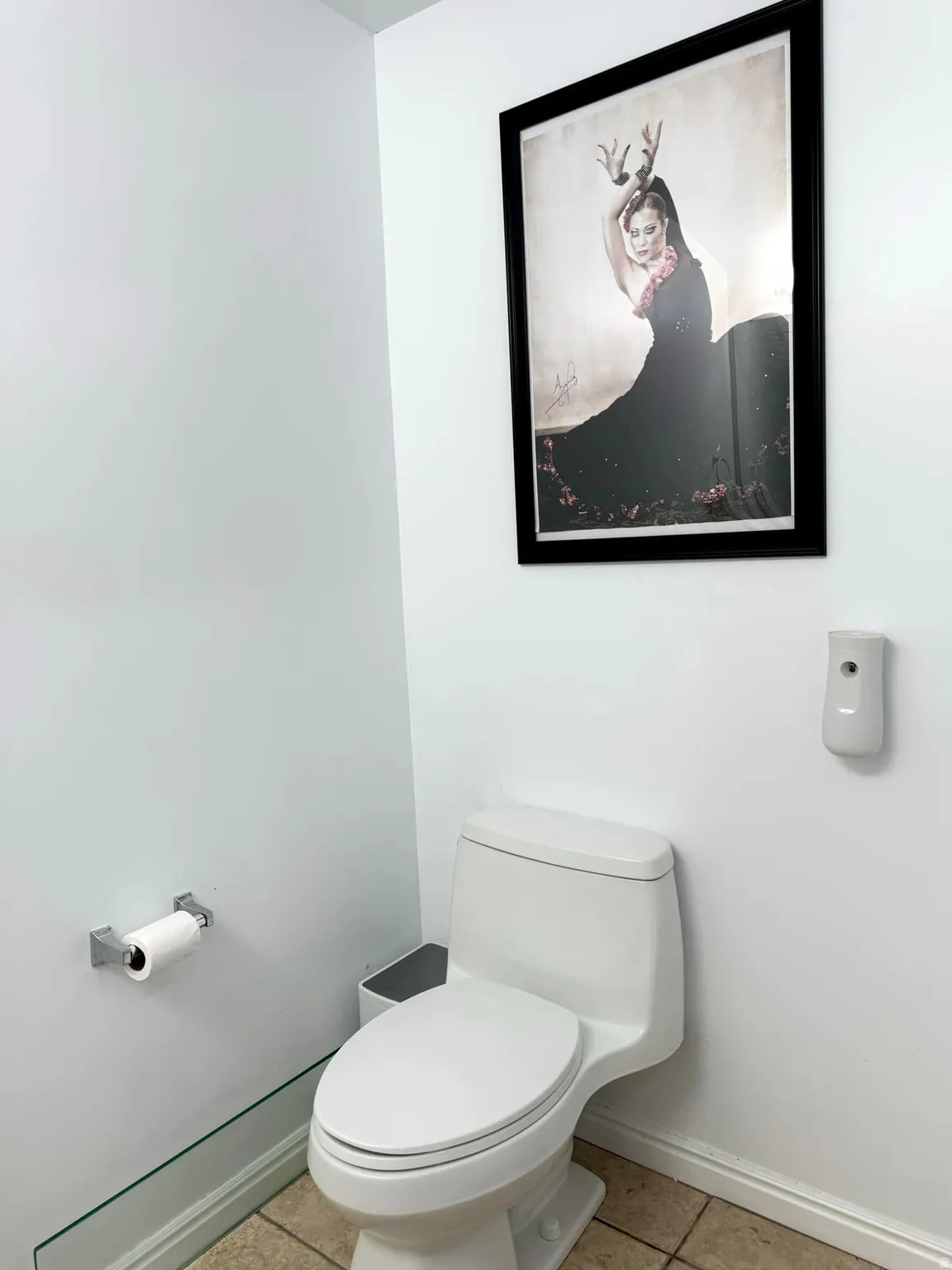 Bathroom featuring baseboards and light tile patterned floors