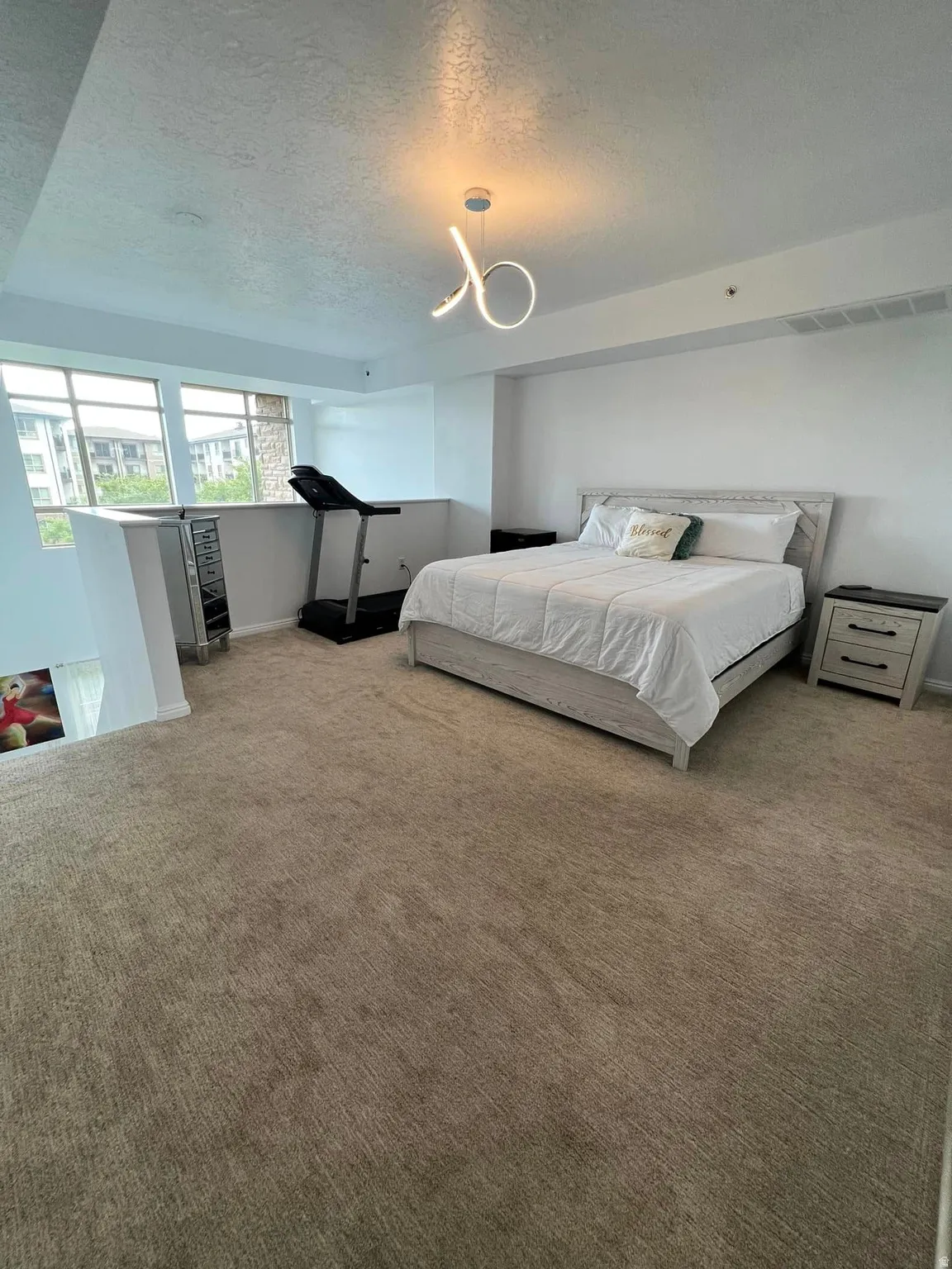 Bedroom with carpet and a textured ceiling