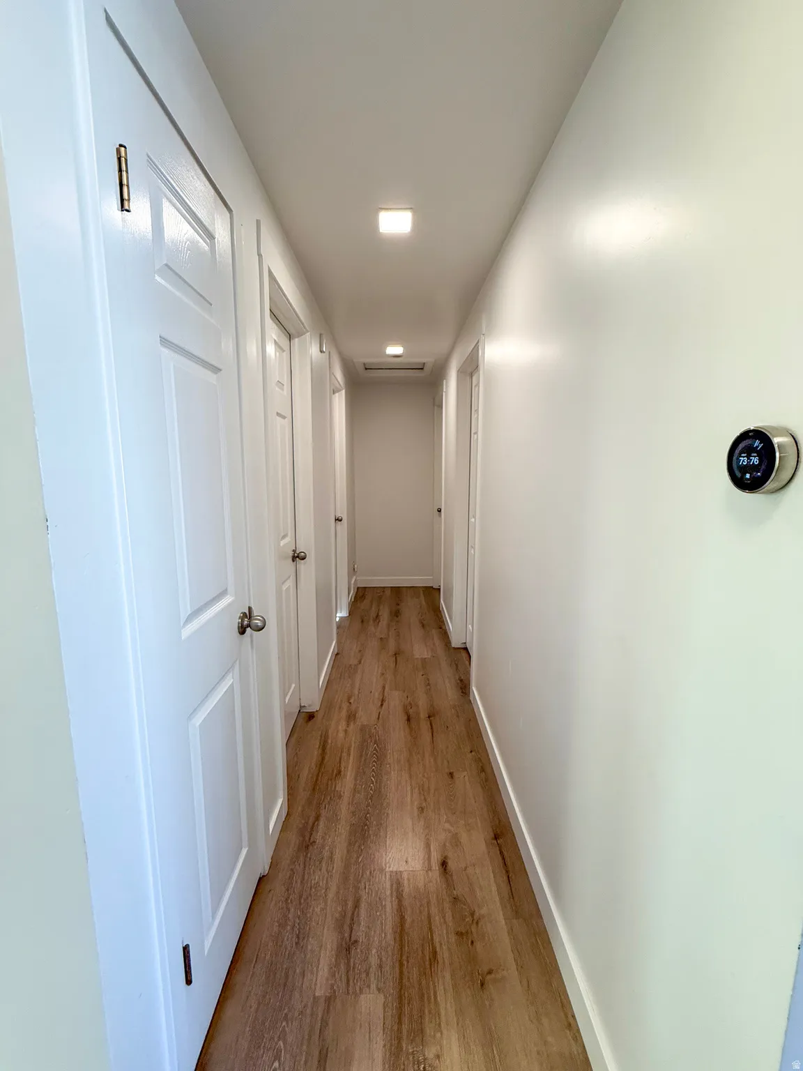 Hall featuring light wood-style flooring and baseboards
