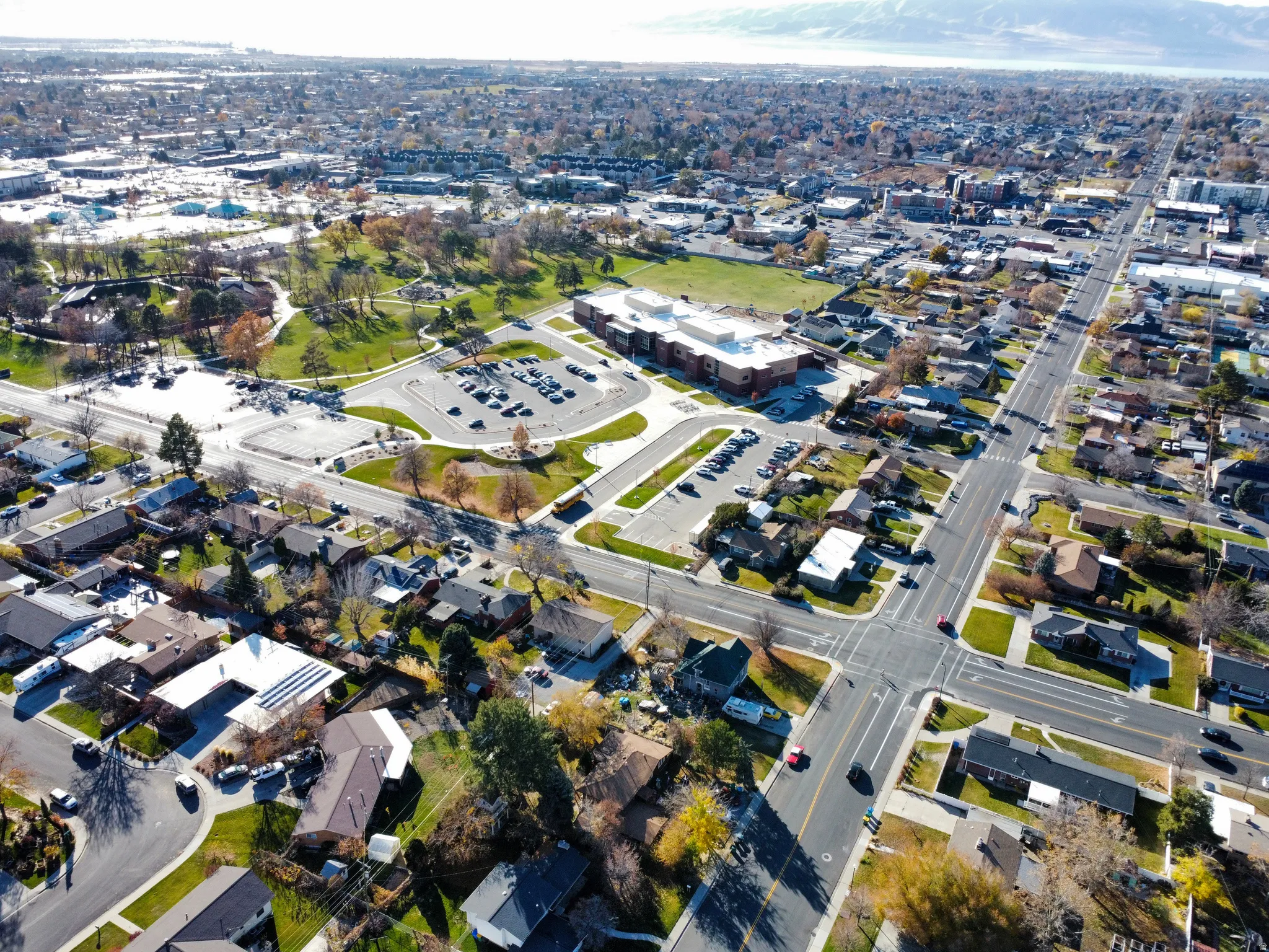 Aerial view of property and surrounding area with nearby suburban area