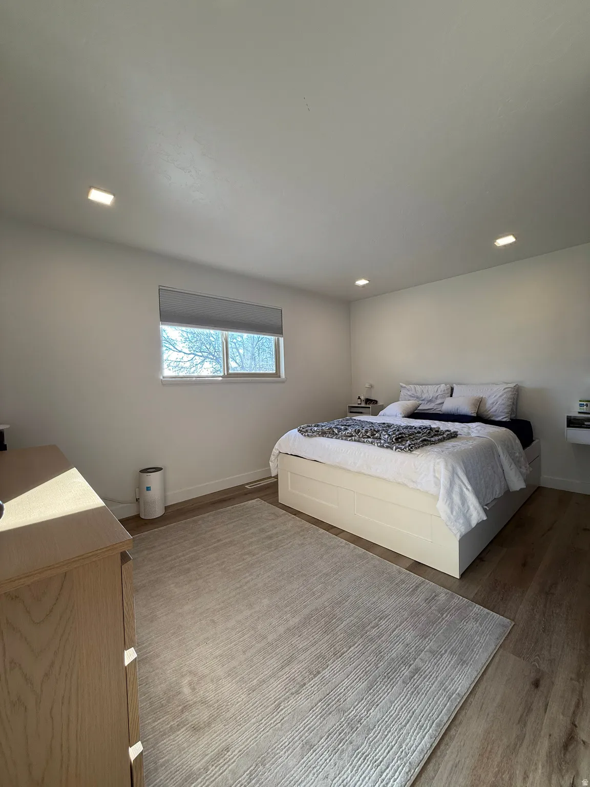 Bedroom with light wood-style floors and recessed lighting