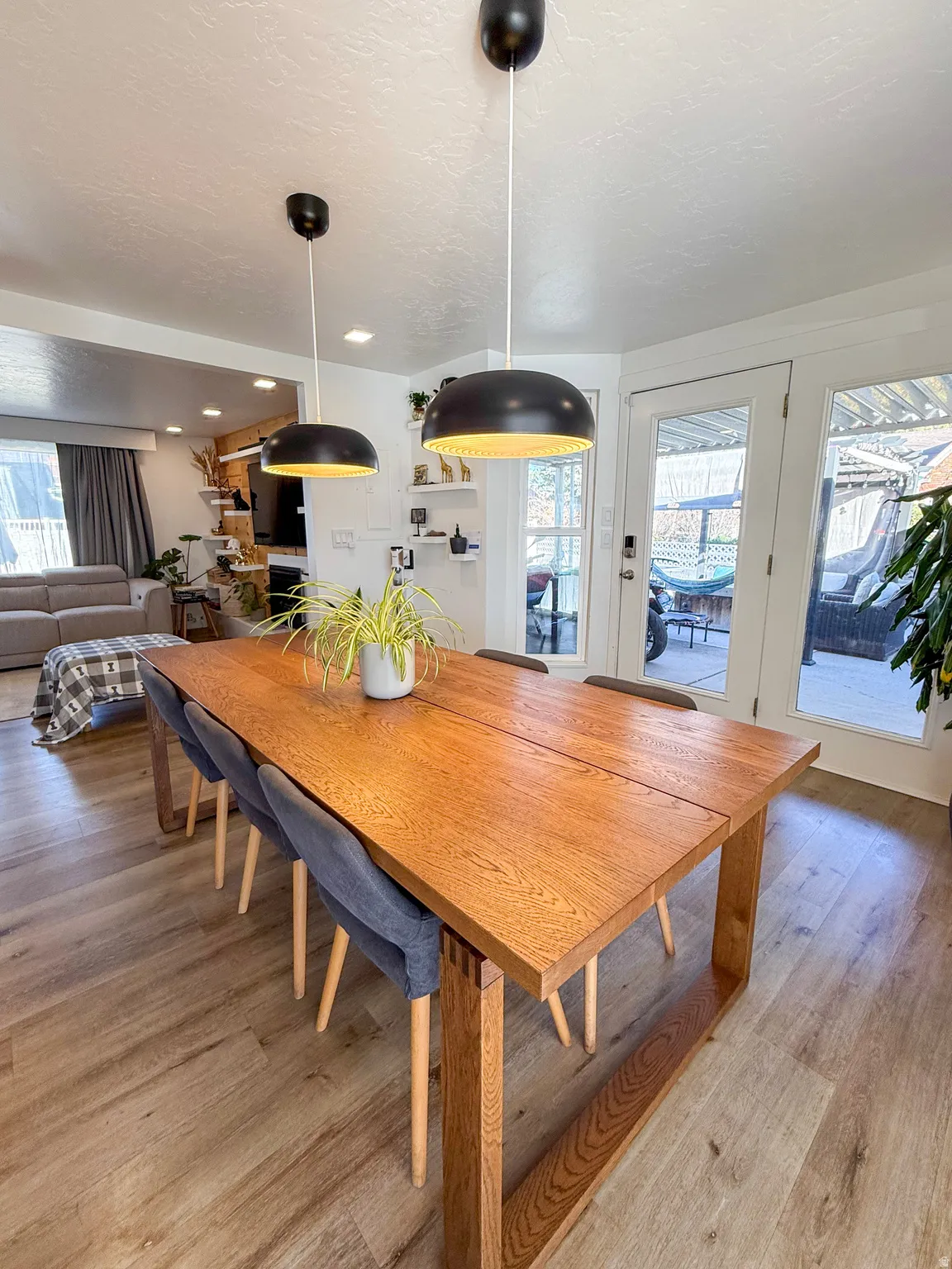 Dining area with light wood-style flooring and a textured ceiling