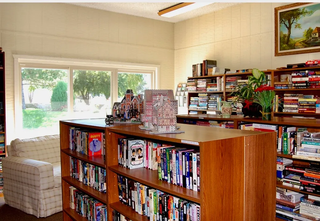 Office area with wall of books and a textured ceiling