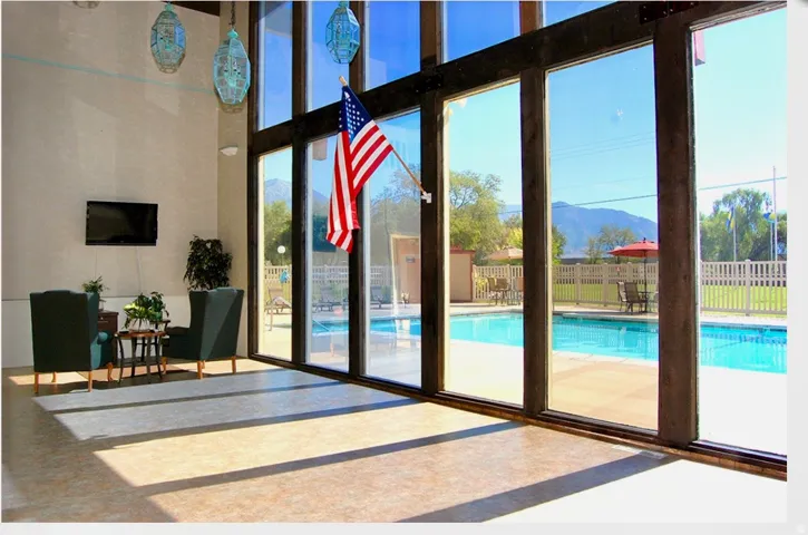 Entryway with a mountain view, a high ceiling, and floor to ceiling windows