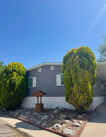 View of property exterior with an attached carport