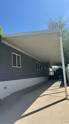View of home's exterior with a carport and a storage unit