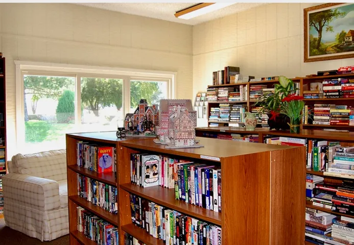 Office area with wall of books and a textured ceiling