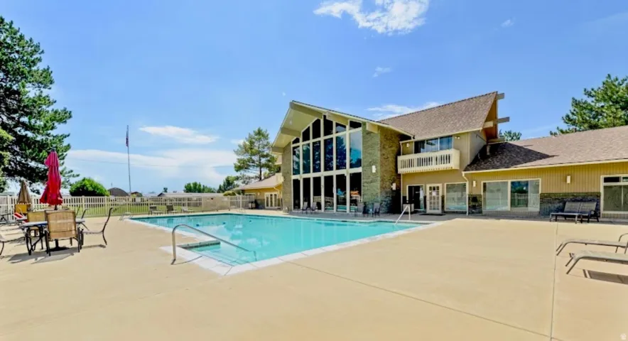 Community pool featuring a patio and a balcony