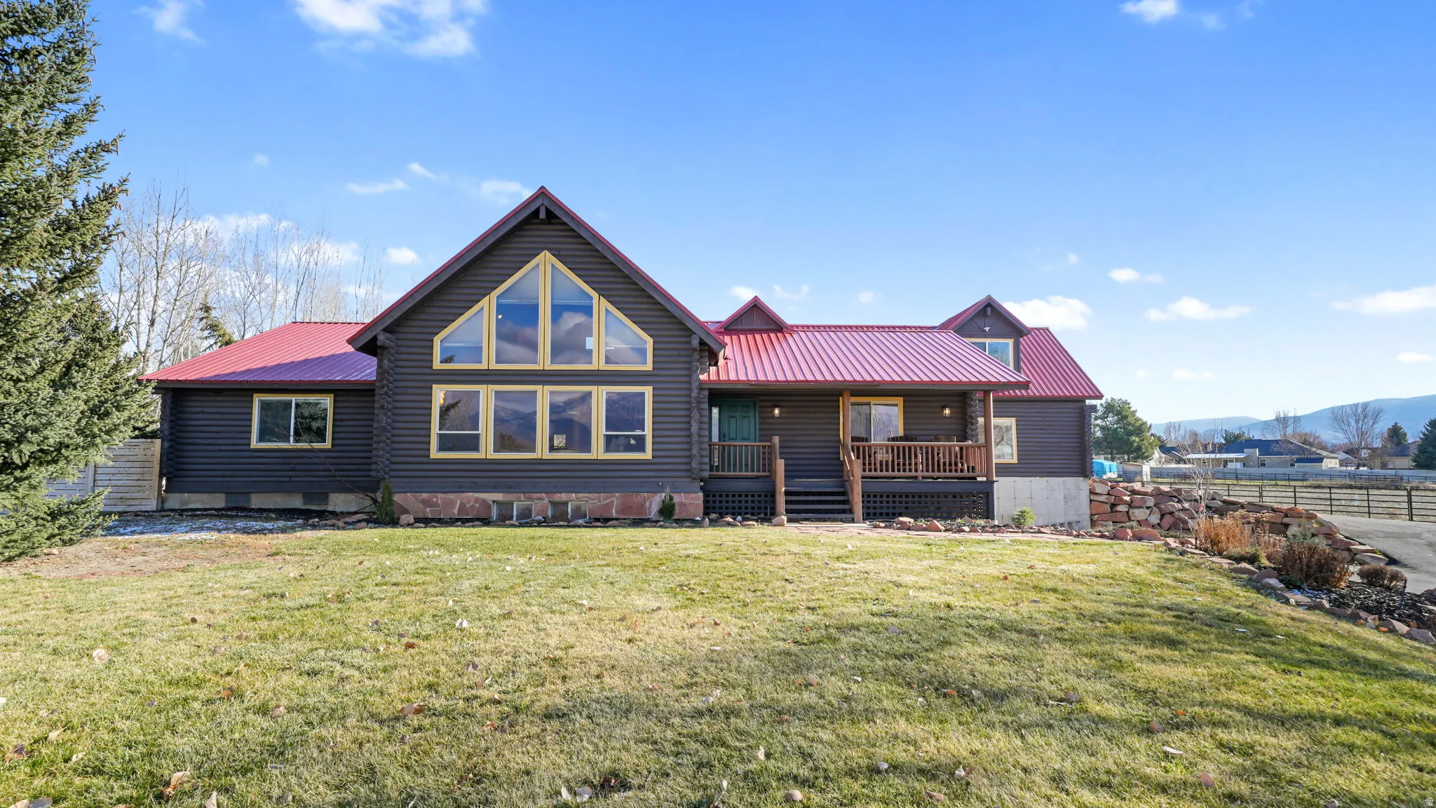 Front view of property with a metal roof and covered porch